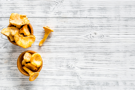Chanterelle mushroom. Fresh raw chanterelles on grey wooden background top view copy spaceの写真素材