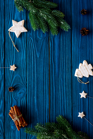 New year symbols. Spruce branch, cones and toys for decoration like spruce and stras on blue background top view.の写真素材