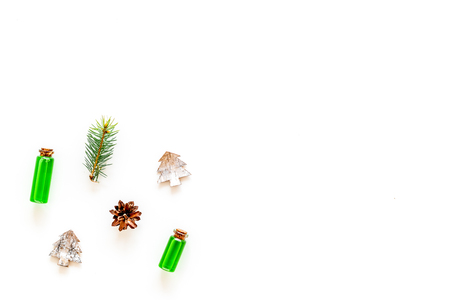 New Year composition with pine sprigs, cones, spruce figure, fir oil on white background top view copy spaceの写真素材
