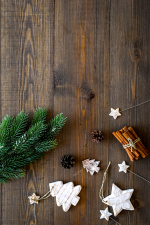 Christmas background. Spruce branch, cones and toys for decoration on dark wooden background top view space for textの写真素材