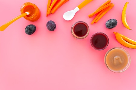 Ingredients for baby puree. Assortment of flavors of baby food. Vegetables and fruits. Apple, carrot, pumpkin, prune on pink background top view copy spaceの写真素材