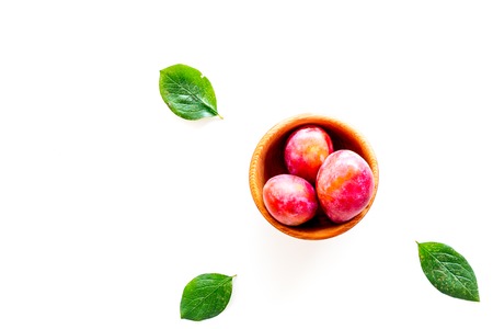 Red plum and leaves pattern on white background top view.の写真素材