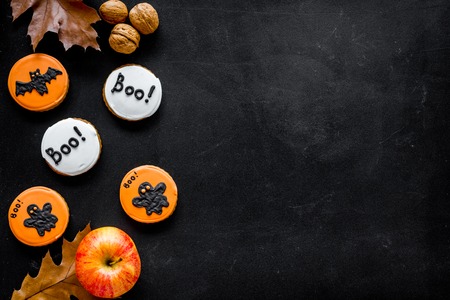 Halloween composition with autumn harvest and cute round hallooween badges with rats, ghousts, Boo text on black background top view.の写真素材
