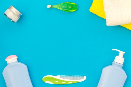 Children's personal care kit. Bath accessories with teeth brush on blue background top view,の写真素材