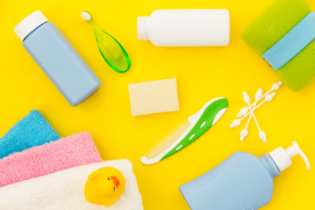 Shower accessories for child. Set with shampoo, towel, soap, gel, towel, brush and yellow rubber...