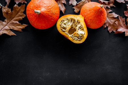 Autumn nature concept. Background with autumn symbols on black background top view