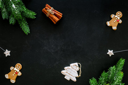 New Year gingerbread cookies. Gingerbread man near coffee, spruce branch, festive decoration on...
