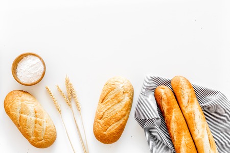 White bread. Fresh rustic homemade bread and loaf on white background top view.の写真素材