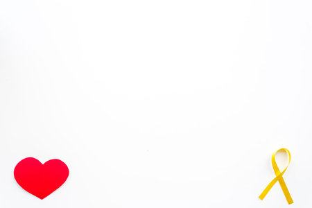 Endometriosis. Gynecological diseases concept. Symbolic yellow ribbon near heart sign on white...