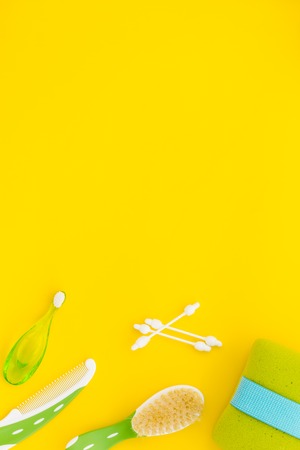Children's personal care kit. Bath accessories with teeth brush on yellow background top view.の写真素材