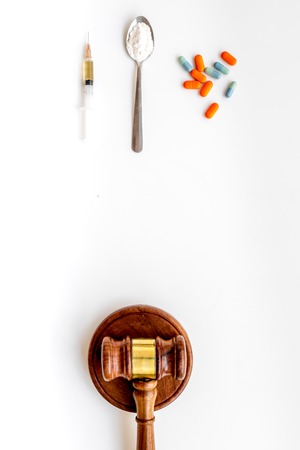 Drugs addiction, arrest for drugs. Pills, spoon with powder, syringe on white background top view copy spaceの写真素材