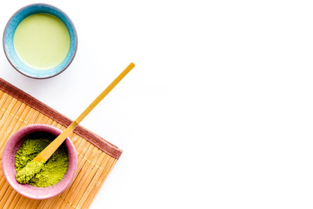 Japanese matcha tea ceremony concept. Matcha powder, ready matcha tea, accessories on white...