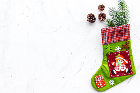 Christmas decoration. Traditional festive socks with spruce branch and pine cones on white...