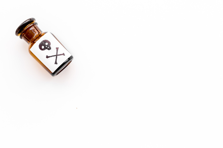 Dangerous addictions, dangerous entertainment. Poison. Bottle with skull and crossbones on white background top view copy spaceの写真素材