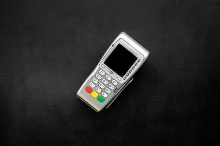 Payment terminal, compact POS terminal on black background top view copy spaceの写真素材