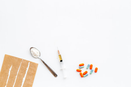 Take drugs, drugs addiction concept. White powder like heroine or cocaine, drug tracks pills, spoon,...