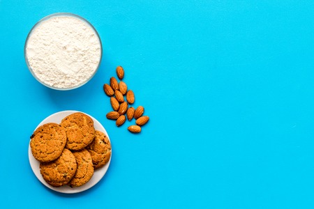 Fresh cookies near flour on blue backgroundの写真素材