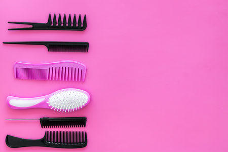 Set of professional hairdresser tools with combs on pink backgroundの写真素材