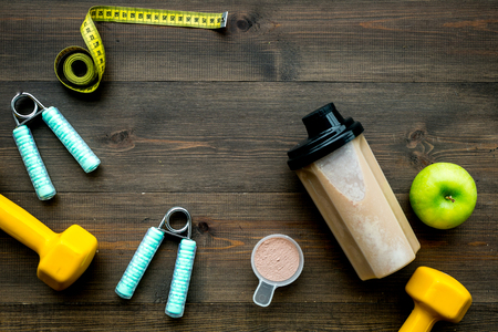 sport diet with protein nutrition and fitness equipment on wooden desk backgroundの写真素材