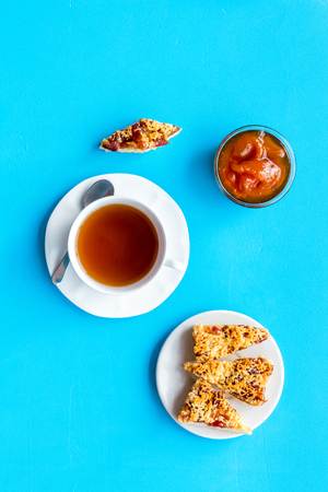 Dessert for evening tea. Cup of tea, fresh homemade cookies on blue background top viewの写真素材