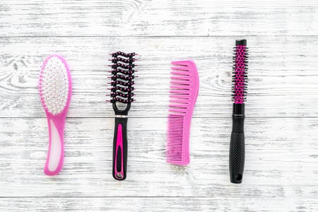 female hairdresser desk with accessories and combs on white wooden background top viewの写真素材
