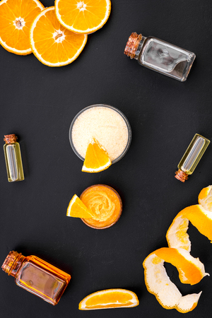 organic cosmetics for homemade spa with orange oil on black background top view patternの写真素材