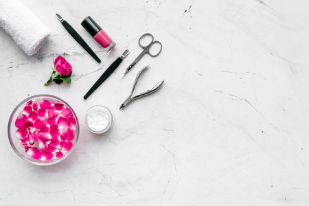 Manicure tools set for nail care on white stone desk background top view mock upの写真素材