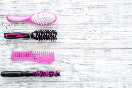 Professional accessories of hairdresser on work desk white wooden background top view mock up.の写真素材