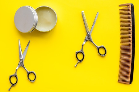 Barbershop desk with tools for male care on yellow background top viewの写真素材