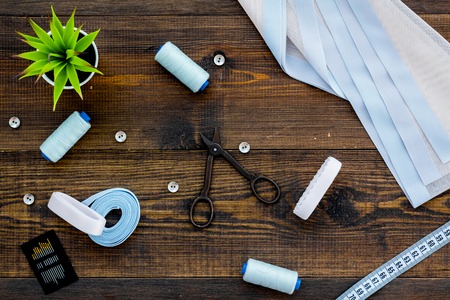 Tailor shop with thread, scissors, fabric. Sewing as hobby. White background top view.の写真素材