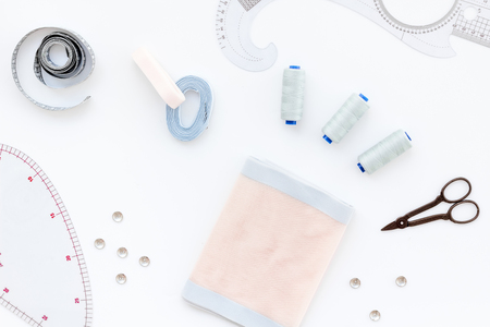 Tailor shop with thread, scissors, fabric. Sewing as hobby. White background top view.の写真素材