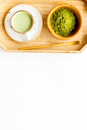 Coffee and cocktails with matcha concept. Matcha latte near bowl with matcha powder on white background.の写真素材