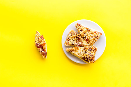 Homemade cookies made of shortcake dough and jam on yellow background top view.の写真素材