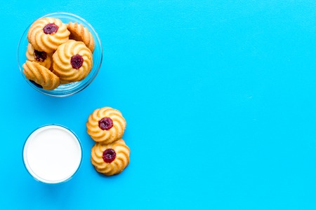 Children tradition evening dessert. Milk and homemade cookies on blue background top view.の写真素材