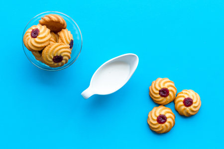 Children tradition evening dessert. Milk and homemade cookies on blue background top viewの写真素材