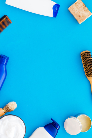 Instruments of male hairdresser with shampoo and comb in barbershop top view on light blue desk background mock upの写真素材