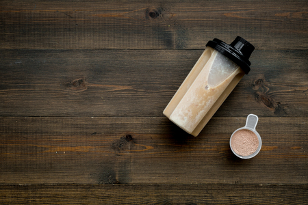 Protein cocktail with powder for sport nutrition set l on wooden desk background top view mock-upの写真素材