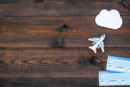 Tourist set with toys and tickets for traveling with kids on wooden background top view mock up