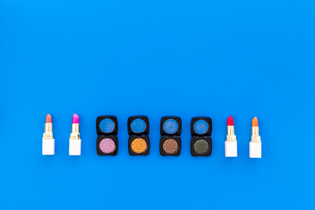 Professional cosmetics set with palette of eyeshadows on blue background top view space for text.の写真素材