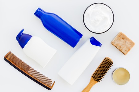 Shampoo bottle and comb for man care in barbershop on white background top view mockupの写真素材
