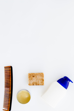 Male care set for barbershop with shampoo bottle and comb on white desk background top view mock-upの写真素材