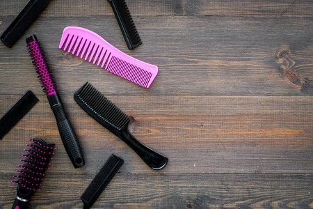 Professional accessories of hairdresser on work desk wooden background top view mock-up.の写真素材