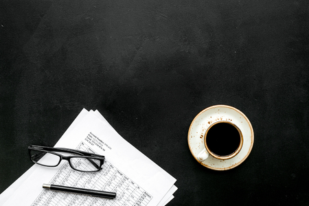 Pencil, glasses, documents, cup of coffee for business lunch in office on blackの写真素材