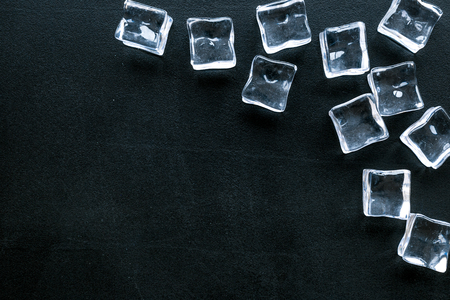 Bar desk with ice cubes on blackの写真素材