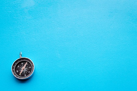 Direction concept with compass on blue background top view space for textの写真素材