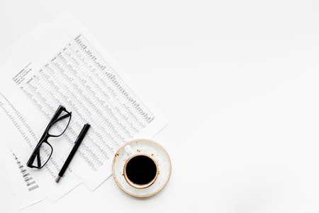 Breakfast in office with black coffee on the work desk with documents and glasses on white background top view space for textの写真素材