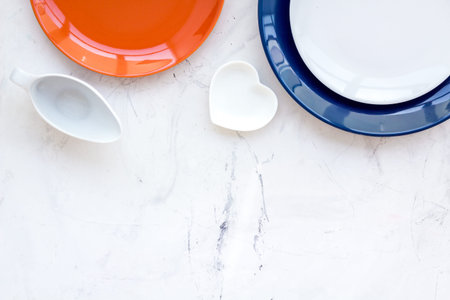 Table setting with plates and flower on stone kitchen table background top view copy space