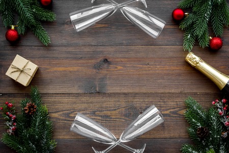 New Year celebration with spruce branch, champagne and glasses wooden table background top view mock upの写真素材