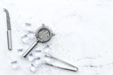 Crashed ice cubes with barman tools on marble kitchen table top view mock upの写真素材