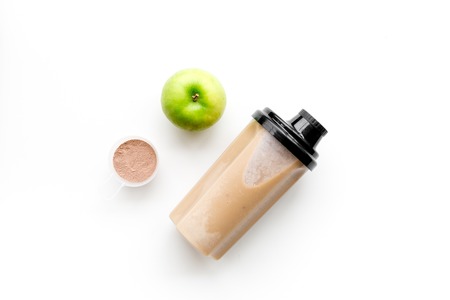 Sport nutrition set with protein powder for cocktail and scoop on white background top view space for textの写真素材
